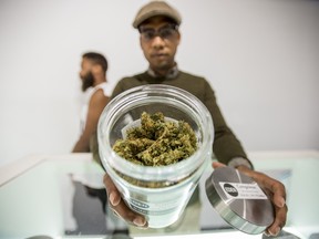 An employee showcases a large jar of marijuana on a shelf  Eden Medicinal Society, a cannabis retailer, in Toronto, Ontario, Tuesday, October 4, 2016.