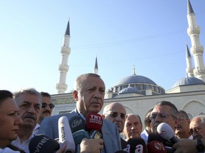Turkey's President Recep Tayyip Erdogan speaks to the media after the Eid al-Fitr prayers in Istanbul, early Sunday, June 25, 2017. Eid al-Fitr marks the end of the Muslims' holy fasting month of Ramadan.(Presidential Press Service, Pool photo via AP)