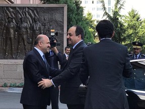 Turkey's Defense Minister Fikri Isik, left, welcomes Qatar's Defense Minister Khalid bin Mohammed al-Attiyah in Ankara, Turkey, Friday, June 30, 2017. Al-Attiyah held talks with his Turkish counterpart on Friday as the Gulf nation's feud with four other major Arab states deepens amid a sweeping list of demands to Doha, including the closure of a Turkish military base there.(Turkish Defense Ministry, Pool photo via AP)