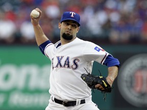 FILE - In this June 6, 2017, file photo, Texas Rangers starting pitcher Dillon Gee throws against the New York Mets in the first inning of an interleague baseball game, in Arlington, Texas. The Minnesota Twins have added two reinforcements for their depleted pitching staff, right-handers Dillon Gee and Trevor Hildenberger. (AP Photo/Tony Gutierrez, File)