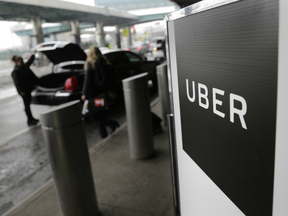 A sign marks a pick-up point for the Uber car service at LaGuardia Airport in New York on March 15, 2017.