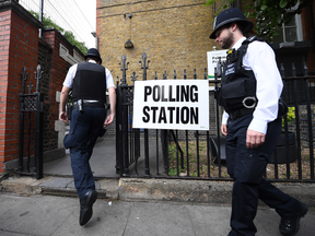 Police officers outside a polling station in London on June 8, 2017.