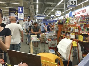 People queue for their turn to pay at a slowly working cash desk in a building supermarket in Kiev, Ukraine, Wednesday, June 28, 2017.  The cyberattack ransomware that has paralyzed computers across the world hit Ukraine hardest Tuesday, with victims including top-level government offices, energy companies, banks, cash machines, gas stations, and supermarkets.  (AP Photo/Efrem Lukatsky)
