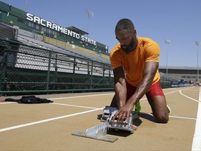 Sprinter Tyson Gay adjusts the starting block before taking a practice run, Wednesday, June 21, 2017, in Sacramento, Calif. Gay will be competing in the 100 and 200 meter races at the USA Track and Field Championships that starts Thursday and runs through Sunday. (AP Photo/Rich Pedroncelli)