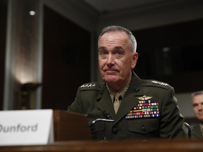 FILE - In this June 13, 2017 file photo, Joint Chiefs Chairman Gen. Joseph Dunford prepares to testify on Capitol Hill in Washington. Dunford said Monday, June 19, 2017, that Washington and Moscow are in delicate discussions to tamp down tensions arising from the U.S. shootdown of a Syrian fighter jet, which the Russians called a violation of a U.S.-Russian understanding on avoiding air incidents.  (AP Photo/Jacquelyn Martin, File)