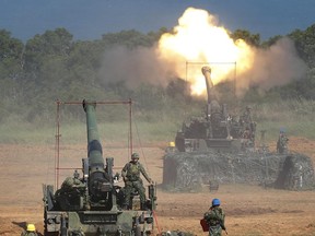 FILE - In this Sept. 10, 2015 file photo, Taiwan's military fire artillery from self-propelled Howitzers during the annual Han Kuang exercises in Hsinchu, north eastern Taiwan. The State Department has approved arms sales to Taiwan worth a total of $1.4 billion, the first such deal with the self-governing island since President Donald Trump took office, officials said June 29, 2017. The sale will anger China, which regards Taiwan as part of its territory. It comes at a delicate time for relations between Washington and Beijing over efforts to rein in nuclear-armed North Korea. (AP Photo/Wally Santana, File)