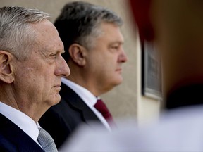 Defense Secretary Jim Mattis, left, and Ukrainian President Petro Poroshenko, right, participate in an arrival ceremony at the Pentagon, Tuesday, June 20, 2017, in Washington. (AP Photo/Andrew Harnik)