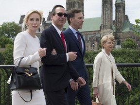 Minister of Finance William Morneau, second right, and his wife Nancy McCain walk with U.S. Treasury Secretary Steven Mnuchin, centre left, and Louise Linton