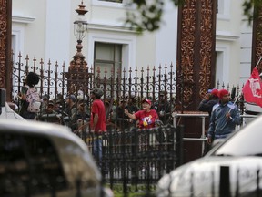 Supporters of Venezuela's President Nicolas Maduro shout slogans against opposition lawmakers as Venezuelan Bolivarian National Guard soldiers dressed in riot gear line up inside the National Assembly building in Caracas, Venezuela, Tuesday, June 27, 2017. Opposition lawmakers got into fisticuffs with national guardsmen as they tried to enter the National Assembly. In a video circulating on social media, the commander of a national guard unit protecting the legislature aggressively shoved congress president Julio Borges as he was walking away from a heated discussion. (AP Photo/Fernando Llano)
