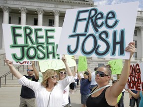 FILE - In this July 30, 2016, file photo, people show their support for Joshua Holt, an American jailed in Venezuela, during a rally at the Utah State Capitol, in Salt Lake City. Still imprisoned after a year, his parents are growing worried their son will die in the Caracas jail with no relief in sight and growing volatility in the South American country. (AP Photo/Rick Bowmer, File)