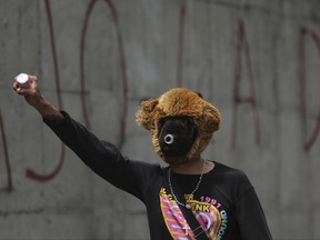 A young man, wearing a makeshift gas mask fashioned from the head of a teddy bear, takes part in a march to the office of Attorney General Luisa Ortega Diaz to show support for the one-time government loyalist, in Caracas, Venezuela, Thursday, June 22, 2017. Venezuela's Supreme Court cleared the way for the prosecution of the country's chief prosecutor, who became a surprise hero to the opposition after breaking ranks with the government of President Nicolas Maduro over his efforts to concentrate power. (AP Photo/Fernando Llano)