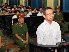 FILE - In this file photo dated Wednesday, Aug. 10, 2011, French-Vietnamese math professor Pham Minh Hoang appears in court in Ho Chi Minh City, Vietnam.  61-year old Pham Minh Hoang was arrested at his home in southern Ho Chi Minh City and forcibly exiled to France, he said during an interview Sunday June 25, 2017. (Hoang Hai/Vietnam News Agency FILE via AP)