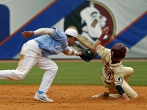 Shortstop Logan Warmoth, left, of North Carolina tries to apply the tag on Florida State's Matt Henderson during ACC action. Warmoth was the top pick of the Toronto Blue Jays at Monday's MLB draft, going 22nd overall. The Jays also grabbed Florida pitcher Nate Pearson with the 28th pick overall.