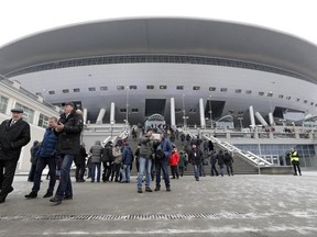 FILE - In this Saturday, Feb. 11, 2017 file photo, spectators visit the new soccer stadium on Krestovsky Island in St. Petersburg, Russia. After years of controversy, Russian officials think their World Cup has weathered the storm. Questions have receded over the legitimacy of the 2010 vote that gave Russia the tournament, the stadiums are either finished or nearing completion, and the Confederations Cup is going smoothly. (AP Photo/Dmitri Lovetsky, File)