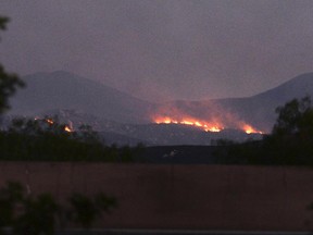 In this photo taken Monday, June 26, 2017, smoke plumes from the Manzanita Fire are seen near Beaumont, Calif. A wildfire in a rugged inland area of Southern California grew substantially overnight. The blaze burning in Riverside County about 80 miles east of Los Angeles is only 10 percent contained Tuesday morning, June 27. Several small communities have been warned to be ready to evacuate. (Micah Escamilla/The Press Enterprise via AP)/The Press-Enterprise via AP)