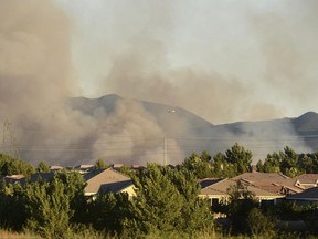 In this photo taken Monday, June 26, 2017, smoke plumes from the Manzanita Fire are seen near Beaumont, Ca. A wildfire in a rugged inland area of Southern California grew substantially overnight. The blaze burning in Riverside County about 80 miles east of Los Angeles is only 10 percent contained Tuesday morning, June 27. Several small communities have been warned to be ready to evacuate. (Micah Escamilla/The Press-Enterprise via AP)