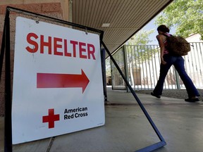 An evacuee from the Goodwin fire enters a Red Cross shelter, Wednesday, June 28, 2017, in Prescott Valley, Ariz. Forest officials say over a dozen campground and other recreation areas have been closed because of the wildfire in northern Arizona. (AP Photo/Matt York)