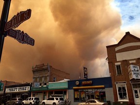 Clouds of smoke from a wildfire approach Panguitch, northeast of Brian Head, Utah, Thursday, June 22, 2017. A wildfire near Brian Head, Utah, that has forced hundreds of people to evacuate has doubled in size in high winds and drove out residents of 400 additional homes, authorities said Thursday. (KUTV via AP)