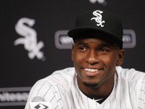 FILE - In this May 27, 2017, file photo, Cuban outfielder Luis Robert smiles at a news conferences after signing with the Chicago White Sox before a baseball game between the White Sox and the Detroit Tiger, in Chicago. A record $203 million was spent on international amateur free agents in the just-ended signing period, nearly $50 million more than the previous high, a figure that will plummet when hard caps of spending start July 2.(AP Photo/Charles Rex Arbogast, File)