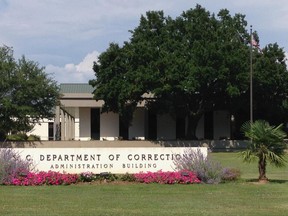 In this June 14, 2017, photo shows the administration building of the South Carolina Department of Correction in Columbia, S.C. A South Carolina inmate says he and another convicted murderer strangled four fellow prisoners in a bid to get the death penalty. Denver Simmons told The Associated Press in a series of telephone calls that he and Jacob Philip plotted the April 7 killings at Kirkland Correctional Institution for months. Both men were sentenced to life without parole for double murderers. The Kirkland institution is a state prison for men operated by the South Carolina Department of Correction. (AP Photo/Jeffrey S. Collins)