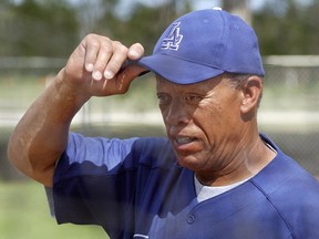 FILE -  In this Feb. 26, 2003 file photo, Los Angeles Dodgers bunting and base running coordinator Maury Wills adjusts his cap during spring training at Dodgertown in Vero Beach, Fla. Former Los Angeles Dodgers great Wills has retired again, this time from broadcasting. The 84-year-old Wills is stepping out of the Fargo-Moorhead RedHawks' broadcast booth after providing color commentary for the minor league team for 22 years.(AP Photo/Richard Drew, File)