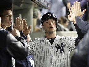 FILE- This June 6, 2017 file photo shows New York Yankees' Matt Holliday celebrating with teammates after scoring during the eighth inning of a baseball game against the Boston Red Sox in New York. Holliday joined Starlin Castro, Aaron Hicks and Greg Bird on the disabled list of the slumping New York Yankees due to a viral infection. Manager Joe Girardi said Wednesday, June 28, 2017 that Holliday returned to New York for more tests. Girardi said doctors ruled out mononucleosis. (AP Photo/Frank Franklin II, file)