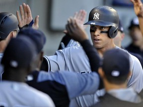 New York Yankees' Aaron Judge celebrates with teammates in the dugout after scoring on a Tyler Austin sacrifice fly during the fourth inning of a baseball game against the Chicago White Sox Monday, June 26, 2017, in Chicago. (AP Photo/Paul Beaty)