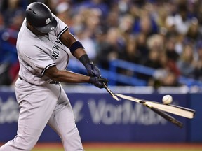 New York Yankees' slugger Chris Carter splinters his bat into pieces after making contact with the ball during MLB action Friday night at Rogers Centre in Toronto. The Yankees were 7-5 losers to the Toronto Blue Jays on this night.