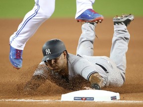 Aaron Hicks of the New York Yankees slides into third base safely during MLB action Thursday at Rogers Centre. Hicks had six RBI in the Yankees' 12-2 victory.