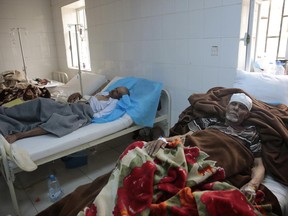 FILE - In this Monday, May 15, 2017 file photo, people are treated for suspected cholera infection at a hospital in Sanaa, Yemen. The U.N. health agency and some major partners have agreed on Wednesday, June 21, 2017 to send 1 million doses of cholera vaccine to Yemen to help stanch a spiraling and increasingly deadly caseload in the impoverished country, which is already facing war and the risk of famine. (AP Photo/Hani Mohammed, file)