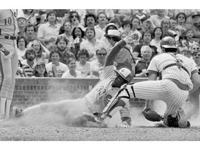 FILE - In this May 23, 1981, file photo, Montreal Expos Tim Raines steals home as Chicago Cubs catcher applies a late tag during the eighth inning of a baseball game in Chicago. The stolen base has been stolen from much of baseball, an afterthought when spring training starts next week. Raines swiped 70 or more each year from 1981-86, among the 808 he accumulated over 23 major league seasons. (AP Photo/Larry Stoddard, File) ORG XMIT: NY183