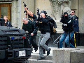 RCMP and Ottawa police escort a Canadian Forces VIP out of a government building during the 2014 terror attack on Parliament Hill