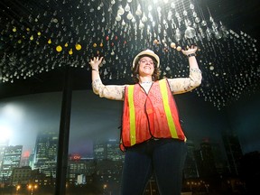 The museum's Director General, Christina Tessier, marvels at the huge art installation being installed made up of 1,867 light bulbs.
