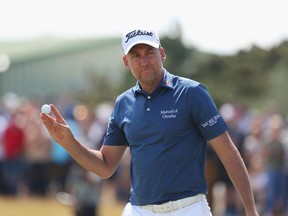 Ian Poulter acknowledges the crowd at the British Open on July 23.