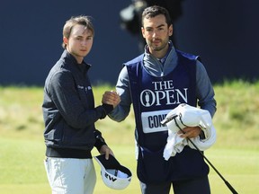 Austin Connelly (left) shakes hands with his caddie on the 18th hole at the British Open on July 20.