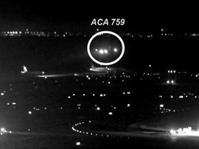 This image released by the National Transportation Safety Board (NTSB) shows Air Canada flight 759 (ACA 759) attempting to land at the San Francisco International Airport in San Francisco on July 7, 2017.  taken from San Francisco International Airport video and annotated by source, shows the Air Canada plane flying just above a United Airlines flight waiting on the taxiway
