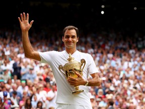 Roger Federer of Switzerland celebrates victory with the trophy after the Gentlemen's Singles final against  Marin Cilic of Croatia on day thirteen of the Wimbledon Lawn Tennis Championships at the All England Lawn Tennis and Croquet Club at Wimbledon on July 16, 2017 in London, England.