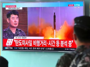 A South Korean soldier watches a television news showing file footage of a North Korean missile launch, at a railway station in Seoul on July 4, 2017. North Korea launched a ballistic missile on July 4, the South's military said, just days after Seoul's new leader Moon Jae-In and US President Donald Trump focused on the threat from Pyongyang in their first summit.