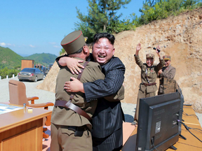 North Korean leader Kim Jong-Un (C) celebrating the successful test-fire of the intercontinental ballistic missile Hwasong-14 at an undisclosed location.