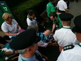 In this July 6 file photo, Bethanie Mattek-Sands is wheeled away on a stretcher after suffering a knee injury at Wimbledon.