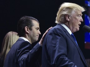 Donald Trump, Jr. with his father, Donald Trump, during a rally on the final night of the 2016 U.S. presidential election.
