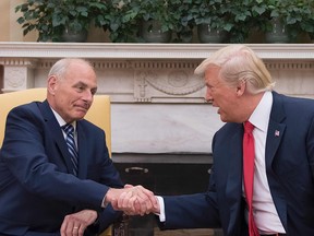 U.S President Donald Trump (R) shakes hands with newly sworn-in White House Chief of Staff John Kelly at the White House in Washington, DC, on July 31, 2017.