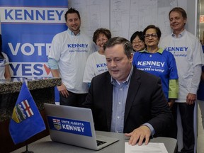 Alberta PC Leader Jason Kenney, centre, casts his ballot in the PC Referendum on Unity at his campaign office in Calgary, Alta., Thursday, July 20, 2017.