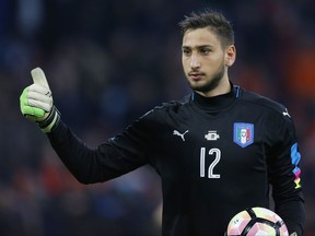 FILE- In this Tuesday, March 28, 2017 file photo, Italy's new goalkeeper Gianluigi Donnarumma gestures during the international friendly soccer match between The Netherlands and Italy at the Amsterdam ArenA stadium, Netherlands. AC Milan's teenage goalkeeper Gianluigi Donnarumma has agreed to extend his contract with the Serie A club until 2021, it was reported on Tuesday, July 11, 2017. (AP Photo/Peter Dejong, File)