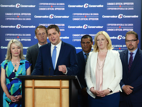 Conservative leader Andrew Scheer, speaking, with his new leadership team, left to right: Candice Bergen, house leader, Chris Warkentin, deputy house leader, Alain Rayes, Quebec political lieutenant, Lisa Raitt, deputy leader, and Mark Strahl, whip.