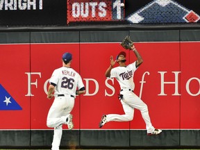 Minnesota Twins center fielder Byron Buxton runs down a Los Angeles Angels deep fly ball in front of right fielder Max Kepler in the eighth inning of a baseball game, Monday, July 3, 2017, in Minneapolis. The Twin won, 9-5. (AP Photo/John Autey)