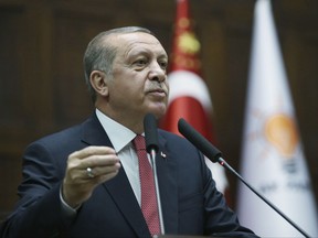 Turkey's President and the leader of ruling Justice and Development Party Recep Tayyip Erdogan addresses his supporters at the parliament in Ankara, Turkey, Tuesday, July 25, 2017.