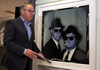 Then-premier Darrell Dexter passes a photo taken by Annie Leibovitz of Dan Aykroyd and John Belushi as the Blues Brothers at the Art Gallery of Nova Scotia in Halifax on June 6, 2013.