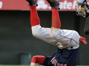 Boston Red Sox's Mookie Betts rolls over after scoring on a hit by Andrew Benintendi during the first inning of a baseball game against the Los Angeles Angels in Anaheim, Calif., Friday, July 21, 2017. (AP Photo/Chris Carlson)