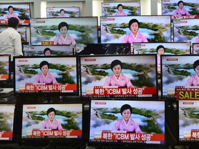 TV screens at a Yongsan Electronic shop show a North Korean newscaster reading a public announcement at in Seoul, South Korea, Tuesday, July 4, 2017. North Korea claims to have tested its first intercontinental ballistic missile in a launch Tuesday, a potential game-changing development in its push to militarily challenge Washington -- but a declaration that conflicts with earlier South Korean and U.S. assessments that it had an intermediate range. The signs read " North Korea claims it successfully launched ICBM." (Lim Tae-hoon/Newsis via AP)